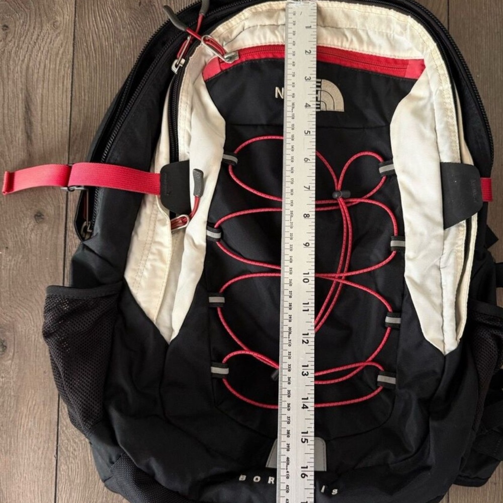 The North Face Black and White Backpack with Red Accents
